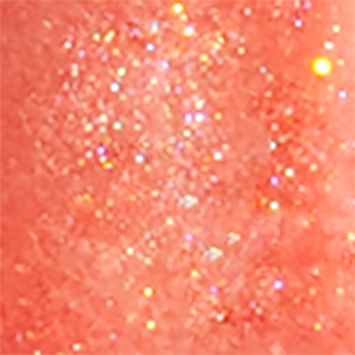 En glitteraktig overflate med rosa bakgrunn og flerfargede, glitrende flekker.