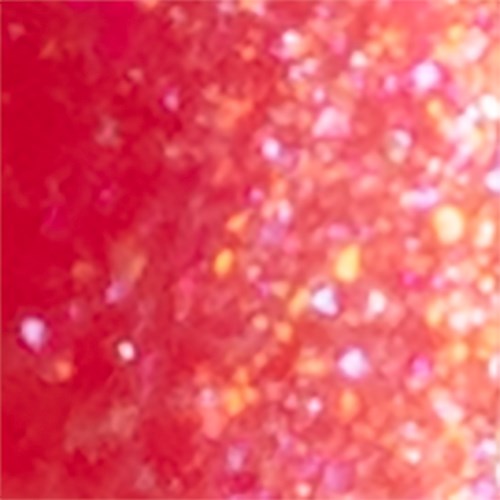 Lys oransje glitter med skinnende, fargede prikker spredt over.
