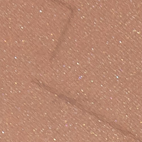 En närbild av brunt skinn med små glitterliknande prickar utspridda överallt.