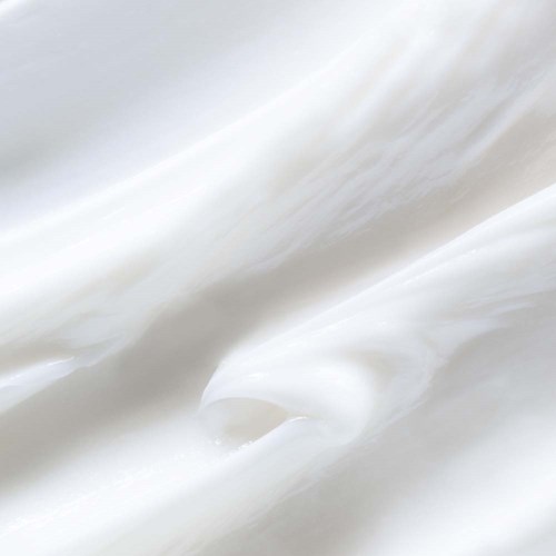 Slät, krämig vit substans med vågor och mjuka kurvor, sannolikt yoghurt eller en liknande mejeriprodukt.