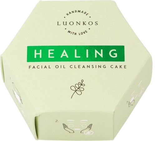 A hexagon-shaped packaging for a facial oil cleansing cake, labeled 'Healing' with a green section and minimal design.