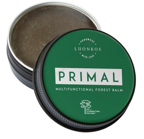 A round tin contains a green label with white text. The product is called Primal, a forest balm for various uses.
