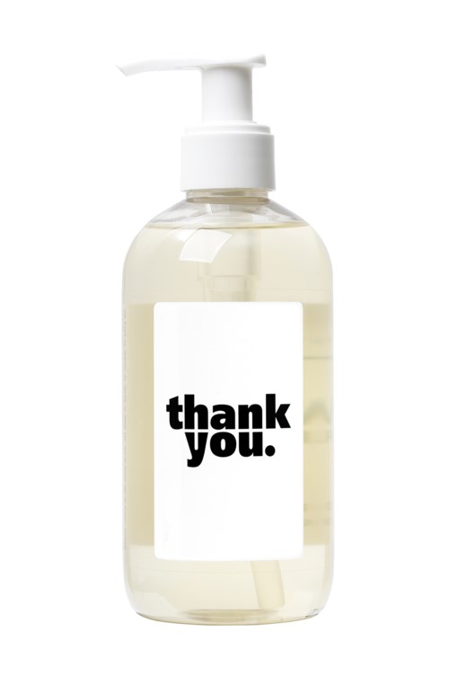En tydlig tvålpump med en 'thank you.'-etikett, fylld med vaxhölje och en vit pump.