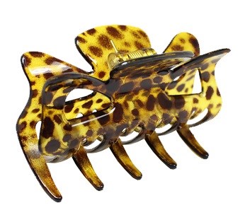 En plastklämma i form av en gepard med fläckar och kattansikte.