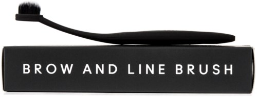 A black eyebrow and line brush with a curved handle resting on a box that says "BROW AND LINE BRUSH."
