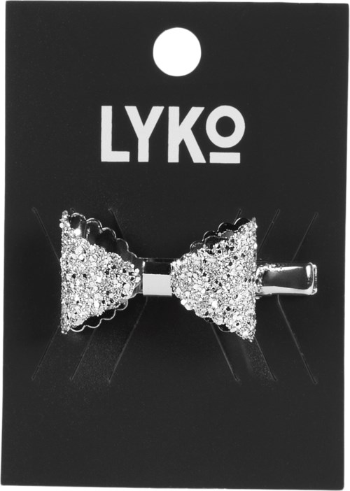 En glittrig hårklämma i form av rosett med silverklämma, fästad på svart kort med vit LYKO-logga.