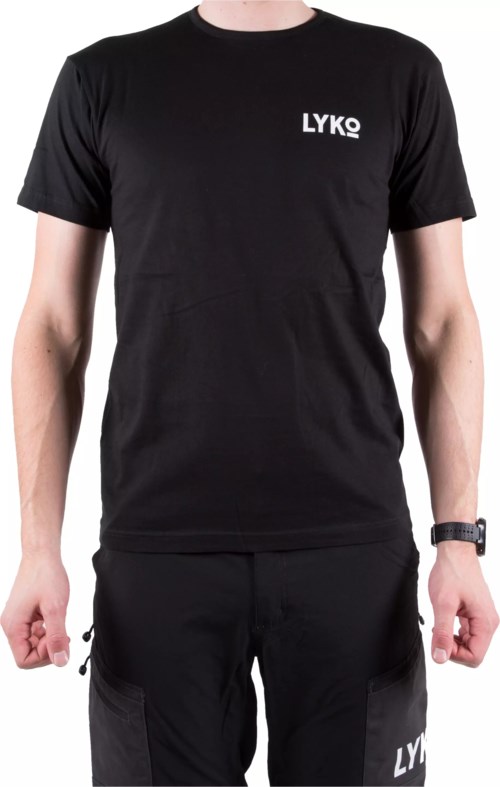 A person wears a black t-shirt with 'LYKO' written on the top left corner and black pants.