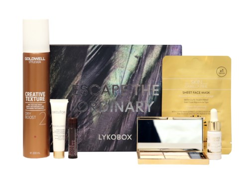 Olika hudvårds- och makeupprodukter, inklusive masker, foundation och en palett, placerade framför en box.