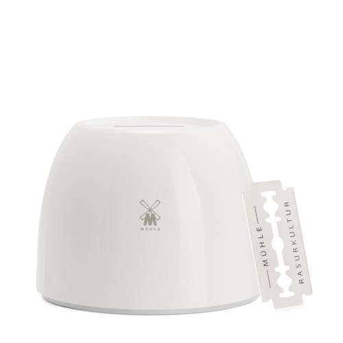 A white kitchen device with a logo of a windmill and a tag attached, used for food preparation.