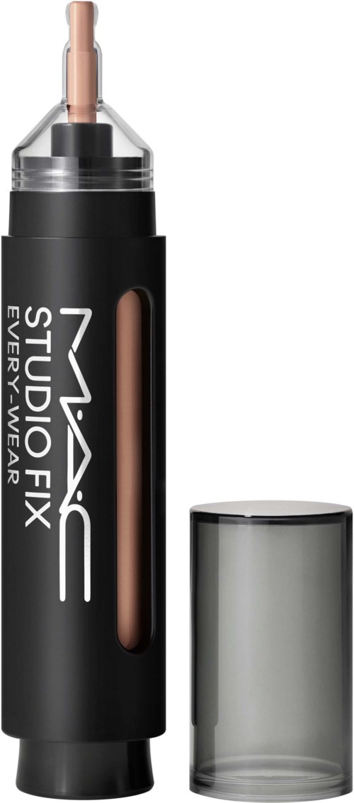 A black tube with a silver cap, labeled MAC Studio Fix, containing makeup product with a beige applicator.