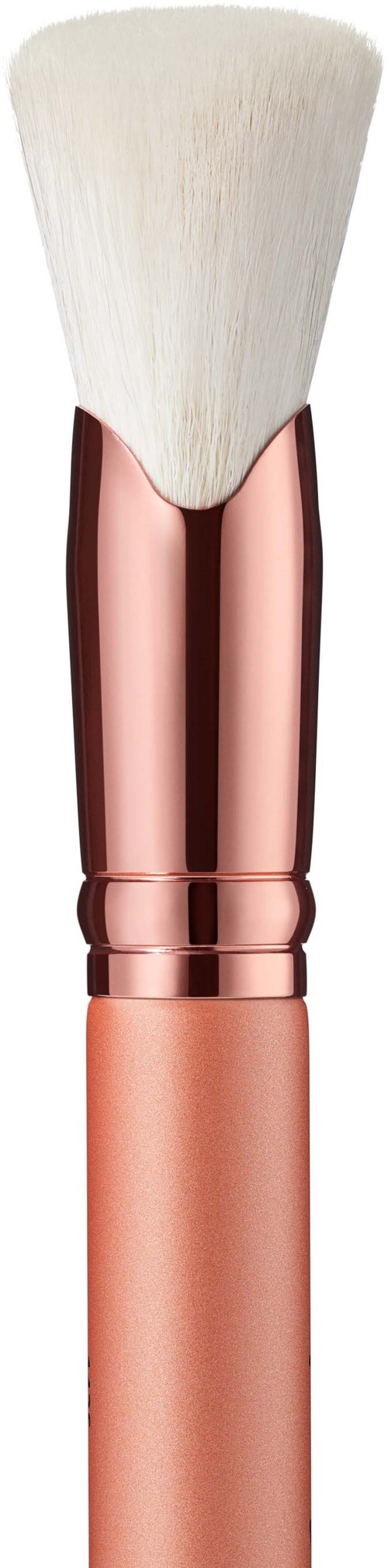 Cosmetic brush with white bristles and rose gold handle against a black background.