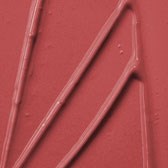Red surface with raised lines and shapes, possibly part of a logo or decorative design.