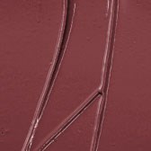 A metal object with two magnetic strips against a reddish background.