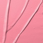 En närbild av en rosa yta med vita streck eller linjer som går över den.