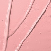 Close-up of pink surface with three thin black lines crossing over it.