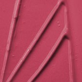 Three pink tongs are placed on a pink surface, with one handle slightly angled to the right.