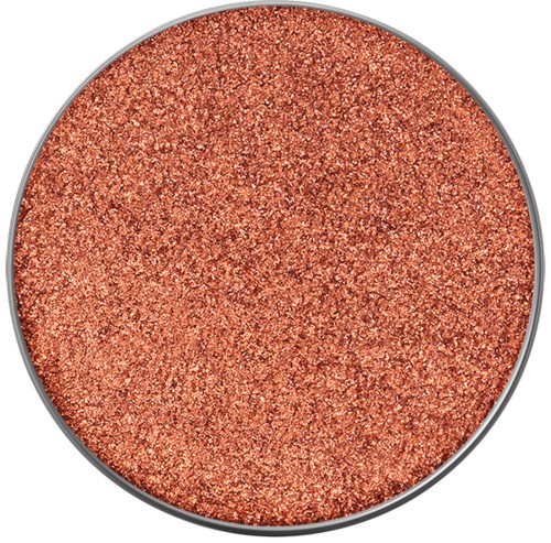 En rund behållare fylld med glitterliknande, orange metallpigment eller pulver.
