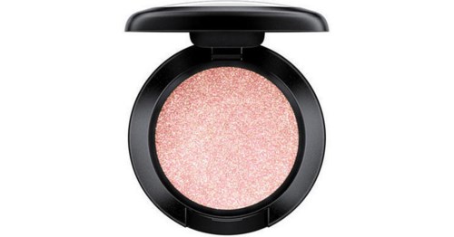 En rund too inuti finns rosa, glitterig makeup och ett svart lock är delvis öppet.