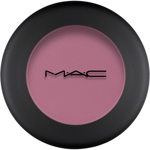 En rund makeup-rouge med svart ytterhölje och rosa mitt, med MAC-logotypen i svart.