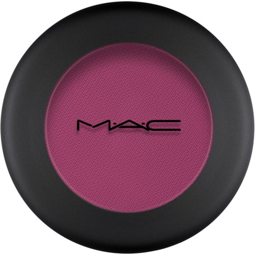 Rundt rosa sminkrouge med svart kant och MAC-logga i svart i mitten.
