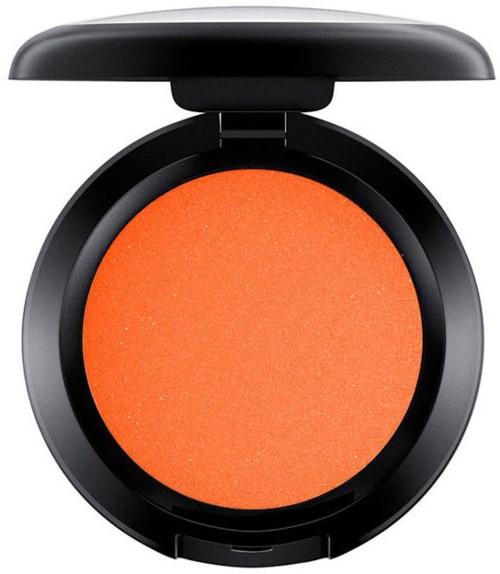 En rund rouge i orangefärg med svart skal och lock öppet.