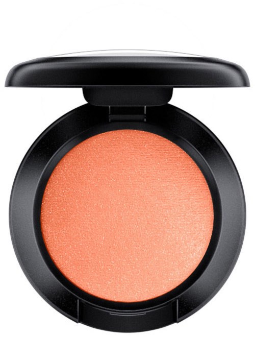 En rund makeup-rouge i en sort compact med låg. Rødfargen er ferskenfarvet med en skinnende finish.