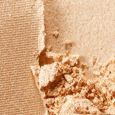 Peeling paint on a wall showing different textures and shades of beige and brown.