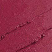 Närbild av rosa-aktig röd yta med sprickor och ojämna delar.