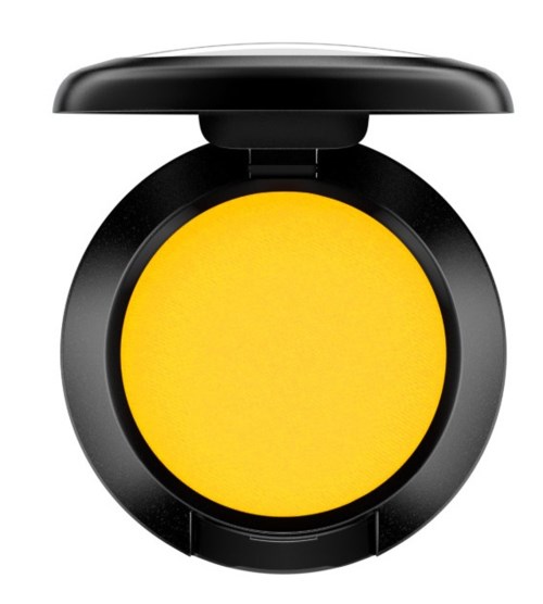 Ett kompakt runt gult makeup-puder i ett svart runt skal med lock.
