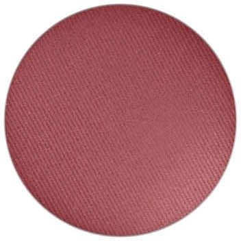 En rund, lyserød makeup blush med en tekstureret overflade.