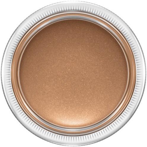 Ein runder Behälter mit beige, glänzender Creme oder Make-up darin. Silber- und weiße Ränder.