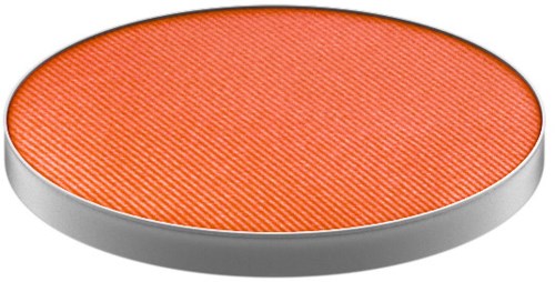 Platt orange cirkulär objekt med texturerad yta och metallkant.