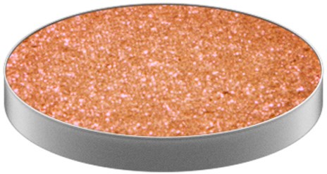 En rund, glitteraktig, oransje overflate med grå kant, som ligner en glittermakeup eller håndverksobjekt.