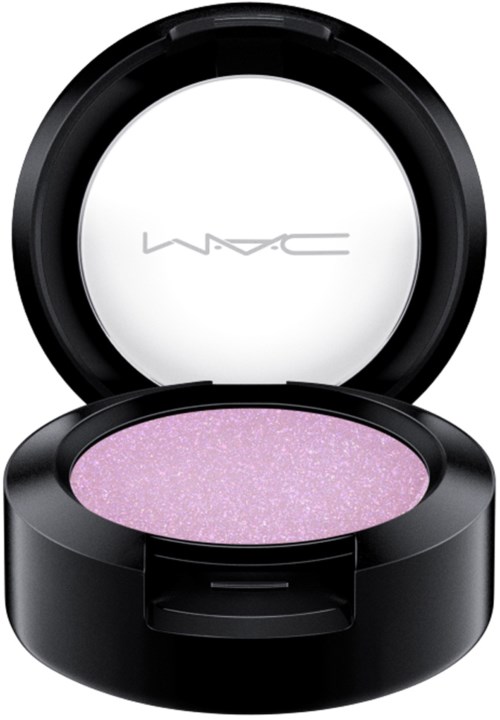 A round black makeup container with lavender-colored, glittery eyeshadow inside. The lid has a faint MAC logo.