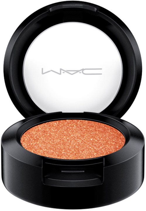A black round makeup container with a white lid, open to show orange shimmer eyeshadow inside.