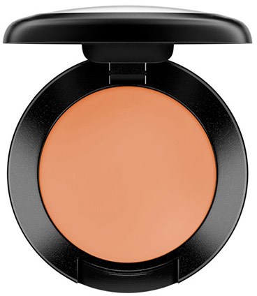 Kleiner runder Make-up-Blush in schwarzem Etui mit Deckel, zeigt puder in Pfirsichfarbe.