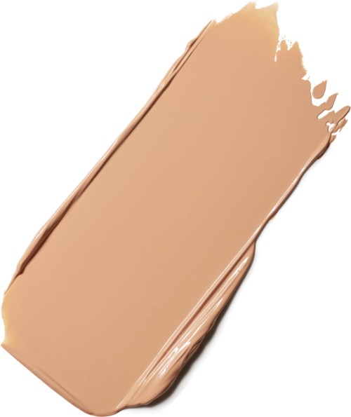 En beige makeup concealer med ujævn kant og smugget udseende.