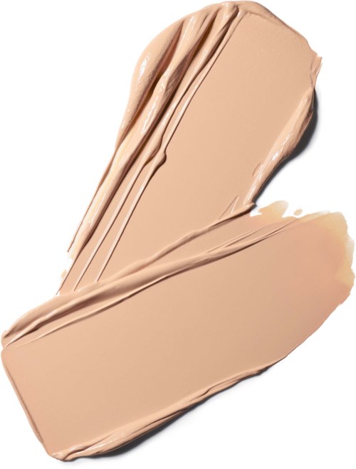 En cremet beige foundationprøve med glat, blended tekstur på hvid baggrund.