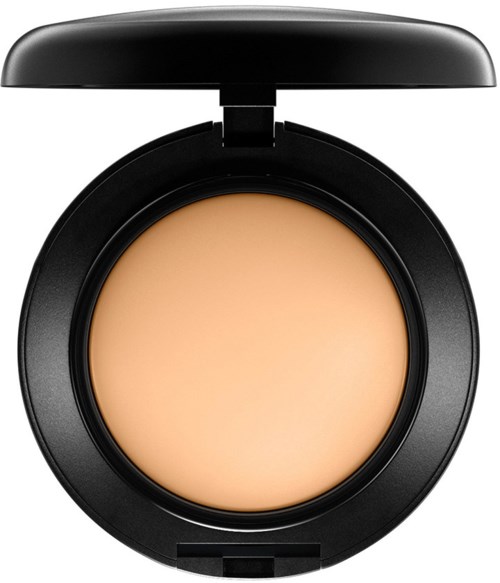 Eine runde Make-up-Box mit beiger Creme, schwarzer Deckel offen.