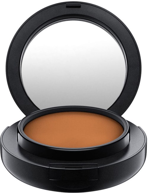 Ein kleines Make-up-Deckel mit Spiegel und orangefarbenem Puder.
