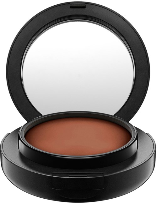 Eine kompakte Make-up-Box mit rundem Spiegel und braunem Kosmetikprodukt.