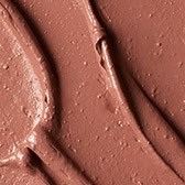Braun Make-up- oder Kosmetikprodukt mit geschwungenen Linien und strukturierter Oberfläche.