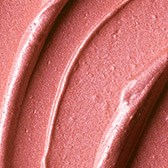 Nahaufnahme von rosa Lippenstift mit glatter, glänzender Oberfläche und gebogenen Linien.