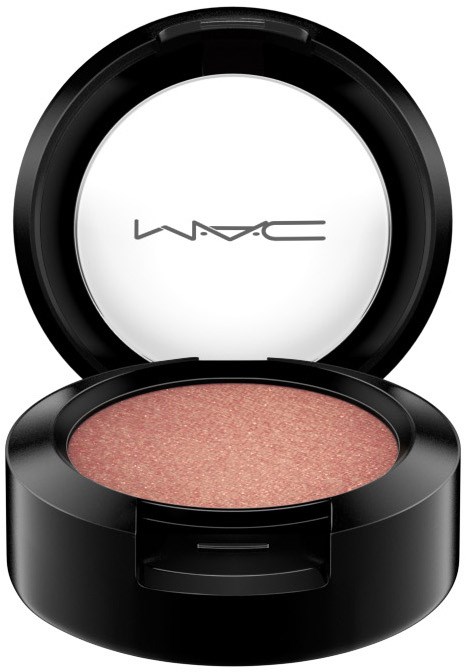 A black round container with a shiny surface, opened to reveal pinkish shimmer makeup inside, and the brand name MAC on the lid.