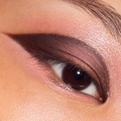 Close-up of an eye with detailed eye makeup, including dark eyeshadow and eyeliner.
