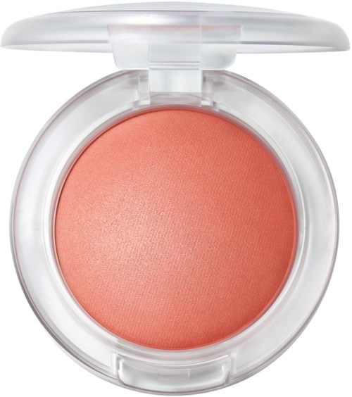 A compact makeup blush in a round, clear plastic case with a light pink color.