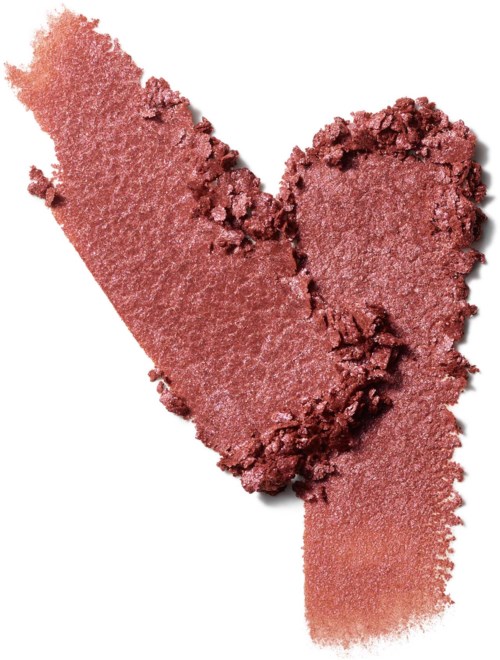 Crushed pink makeup blush applied in a heart shape on a white background.