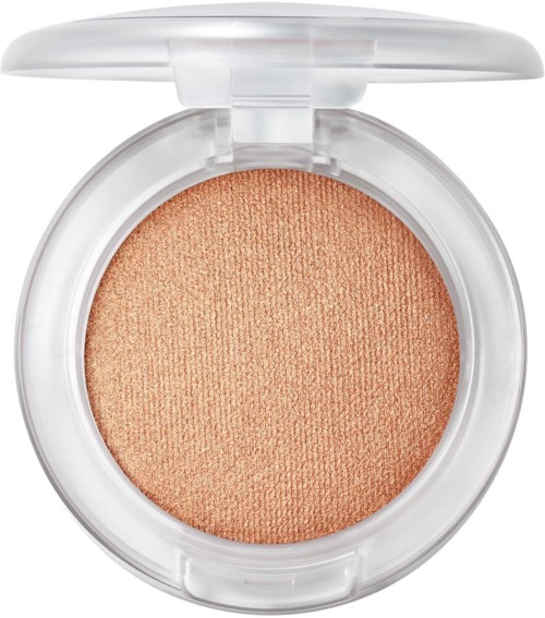 A round compact with peach-colored blush inside and a transparent lid.