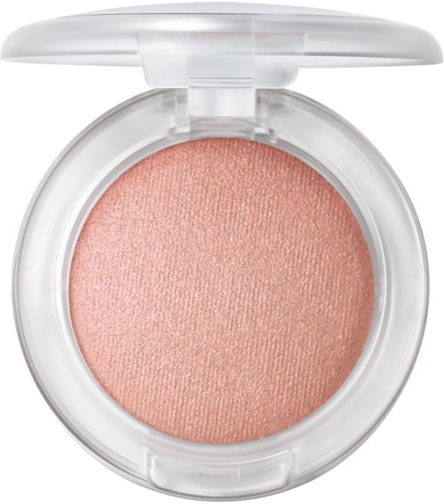 Peach-colored pressed blush in a round clear compact with a transparent lid.
