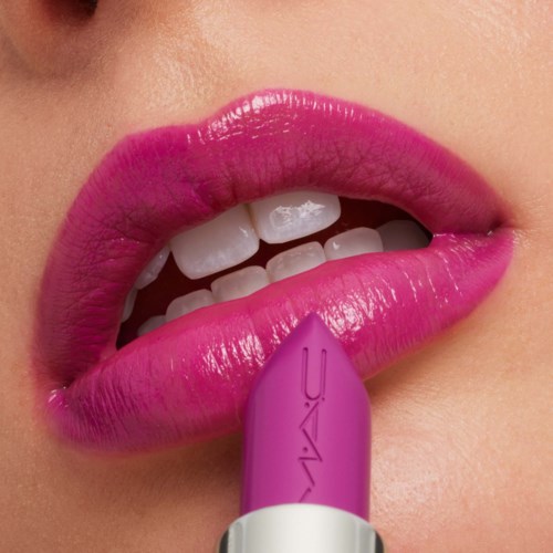 Close-up of pink lips and a person applying lavender lipstick.
